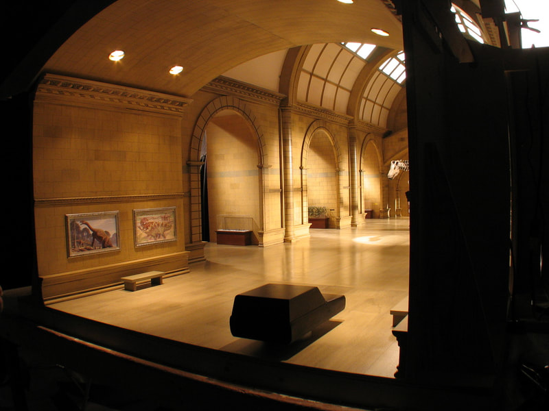 Scale model of museum with miniature care standing in for camera angles. 