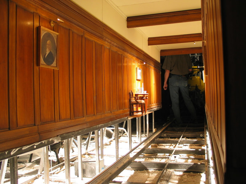 Scale model of a hallway with wood paneling.